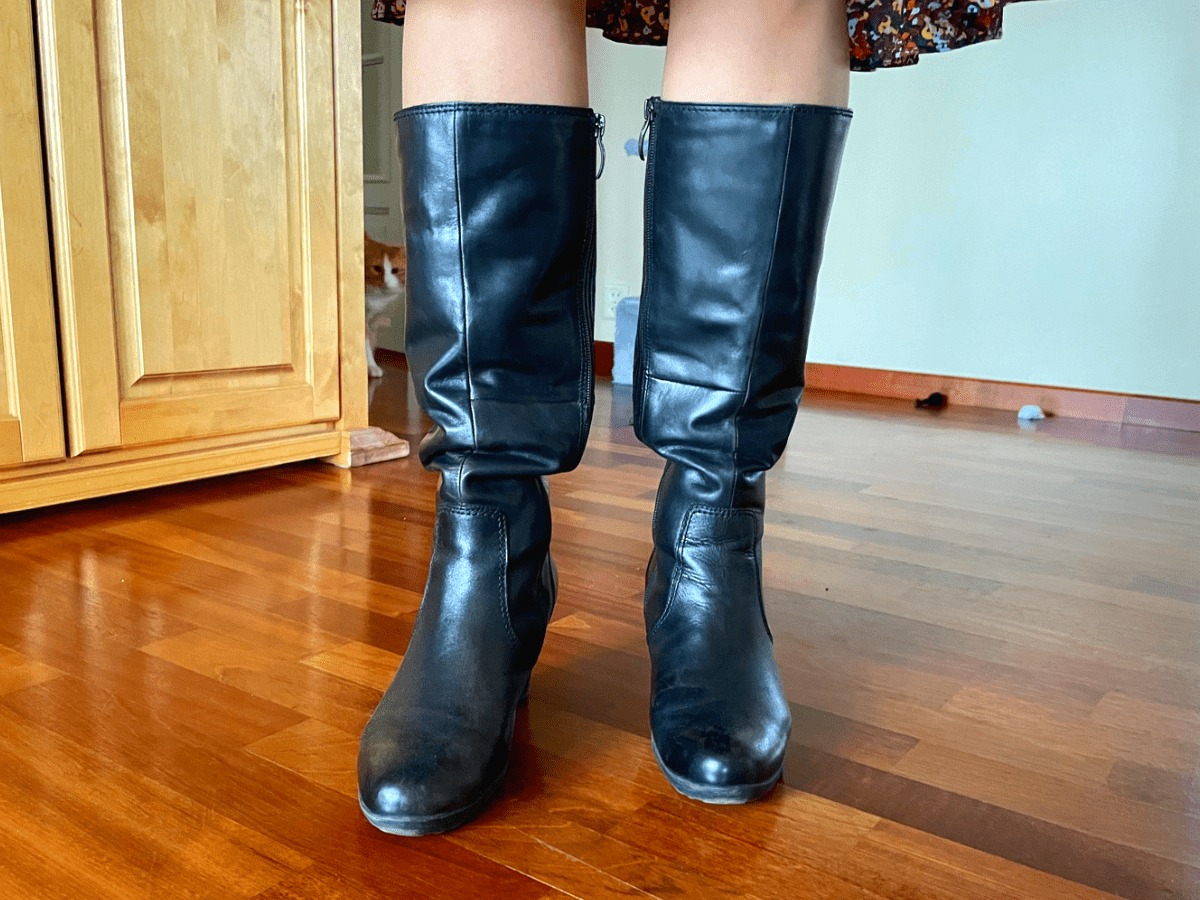 Boots slouching down around the calves showing how a wide shaft causes boots to fall
