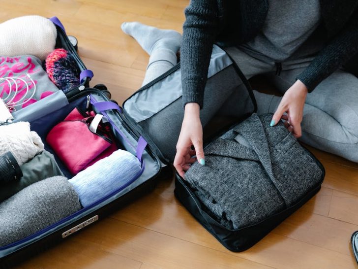 Comfortable layered travel clothes laid out for the in-flight outfit