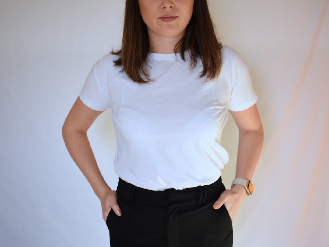 Woman wearing a plain white fitted T-shirt with no visible bra lines, showing the smooth result of wearing the right bra