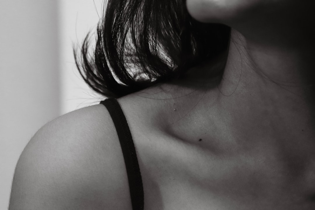 Close-up of a bra strap visible on a woman's shoulder