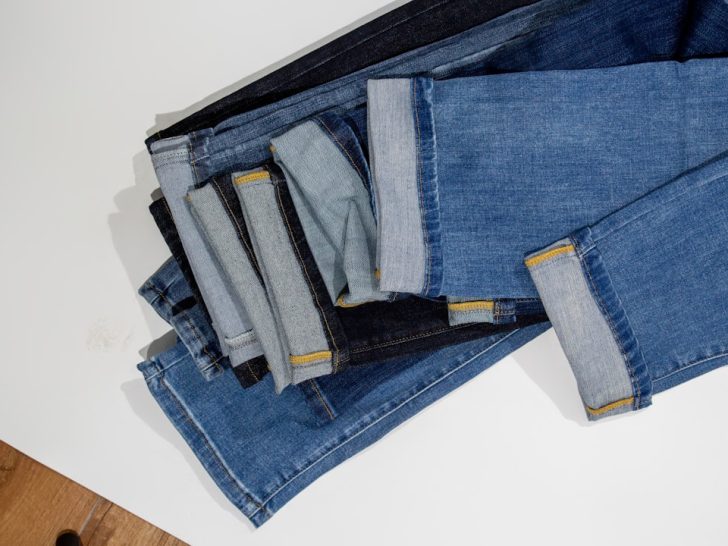 A selection of jeans in different washes and styles for flattering every butt shape. Photo by TuanAnh Blue on Unsplash