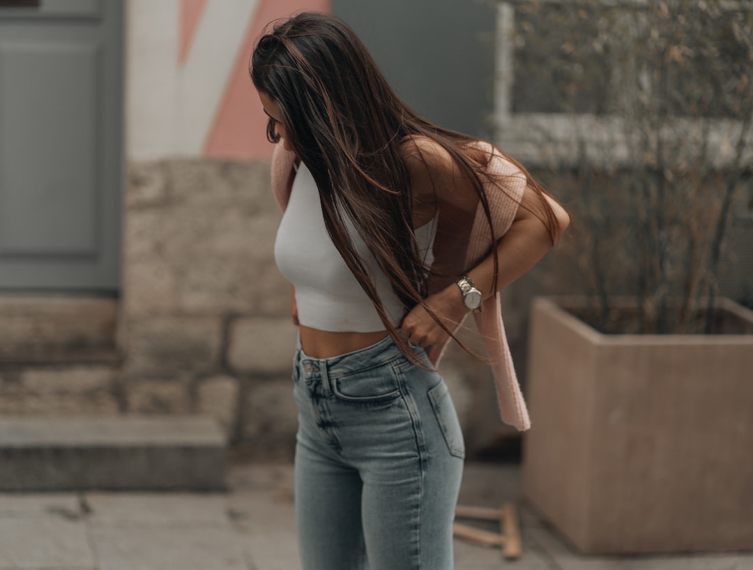 Woman wearing high-waisted jeans showing how rise and pocket placement create a flattering silhouette