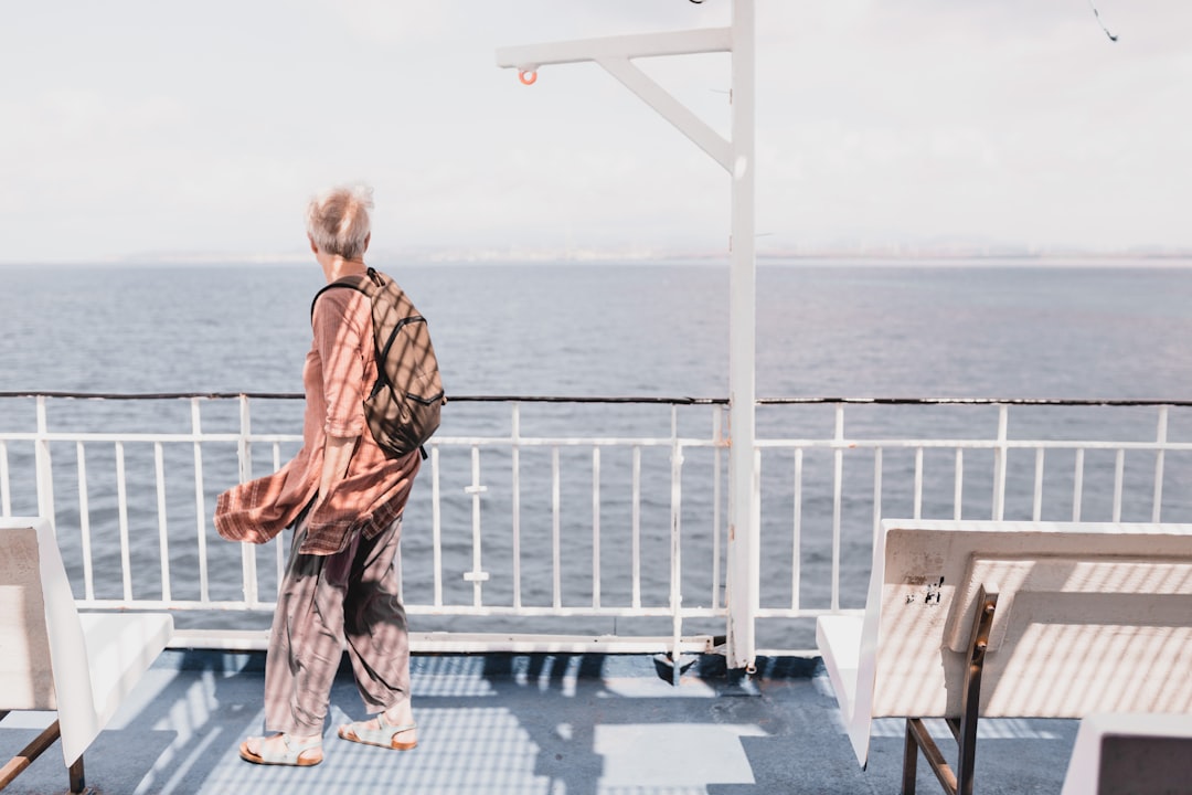 Mature woman traveler with suitcase enjoying solo travel destination