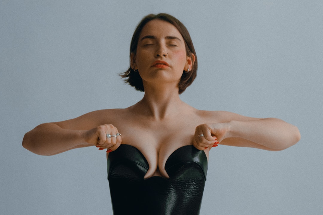 Woman adjusting her neckline to prevent wardrobe malfunction