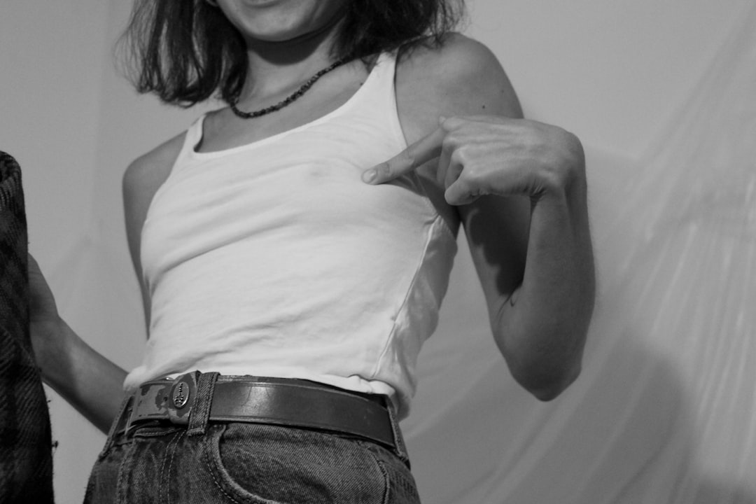 Woman in a thin fitted tank top demonstrating how lightweight fabric shows nipple visibility