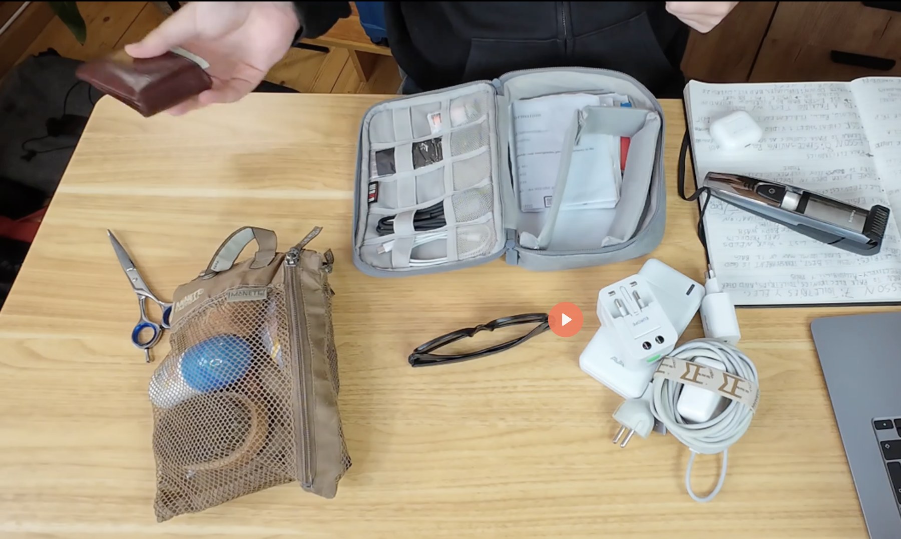 Real-world toiletries and electronics organized on a desk before packing