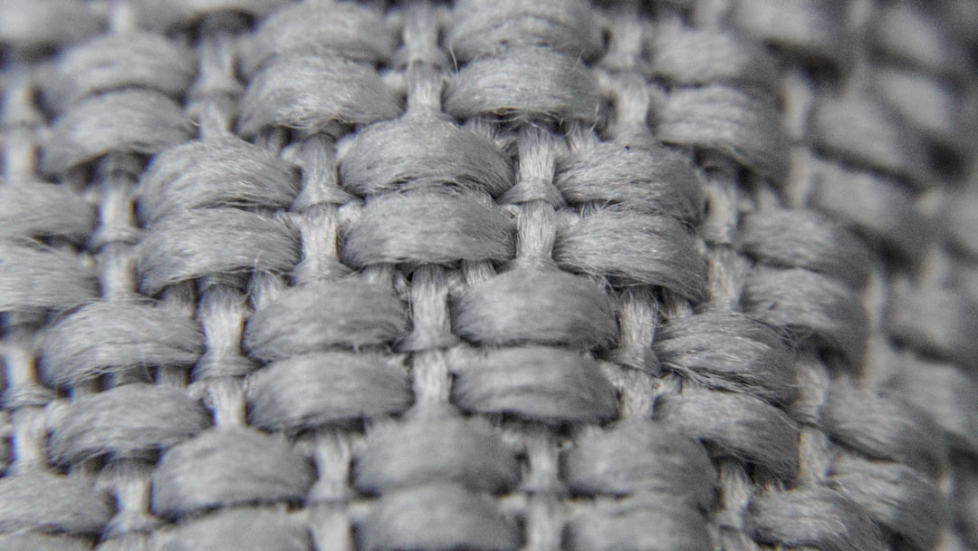 Macro view of structured fabric weave showing the thick tight construction that holds its shape and creates a uniform surface over the body