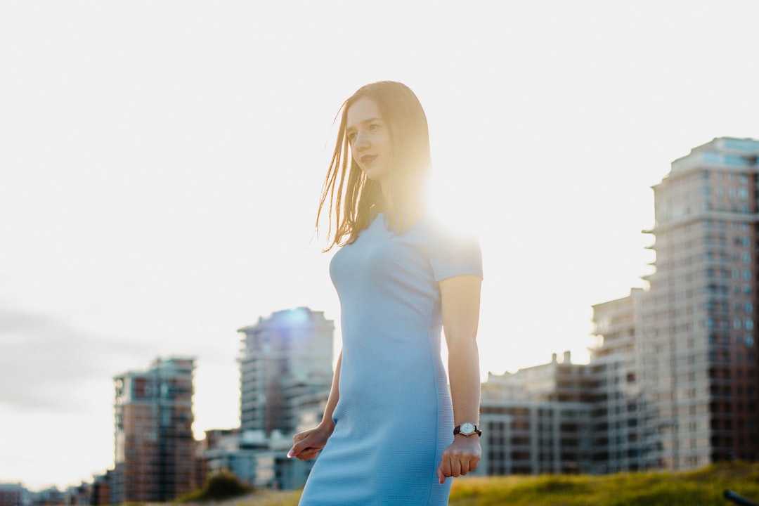 Woman wearing a form-fitting light blue dress with a smooth clean silhouette demonstrating the goal of keeping body parts from showing through clothes