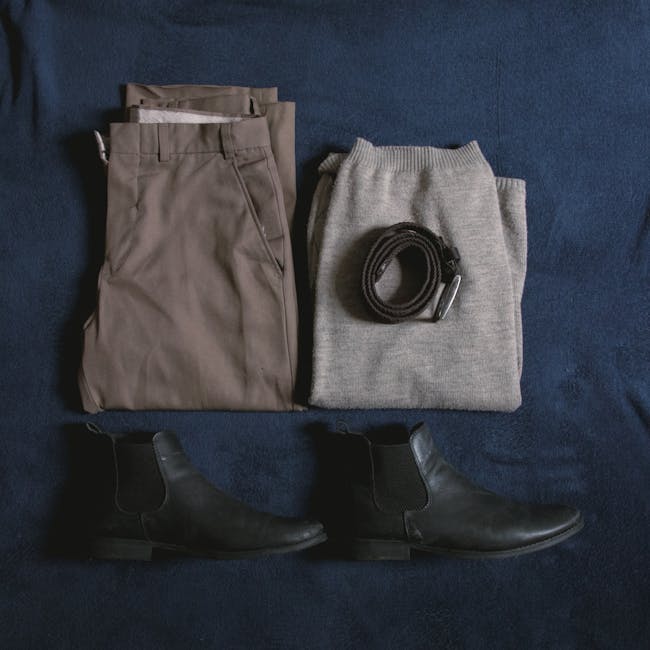 Travel capsule wardrobe of coordinated neutral pieces laid out flat