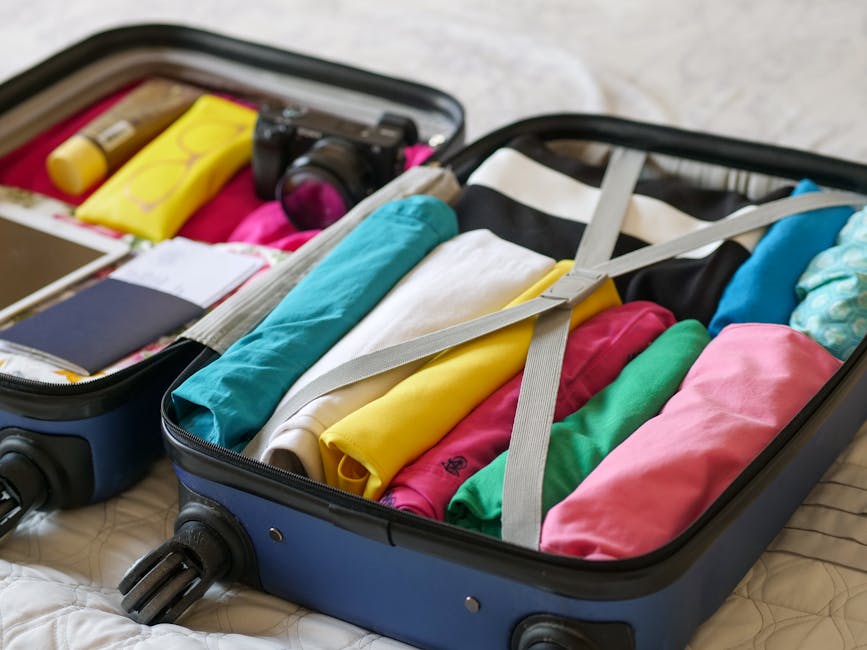Open carry-on suitcase with neatly arranged 7-day packing list contents
