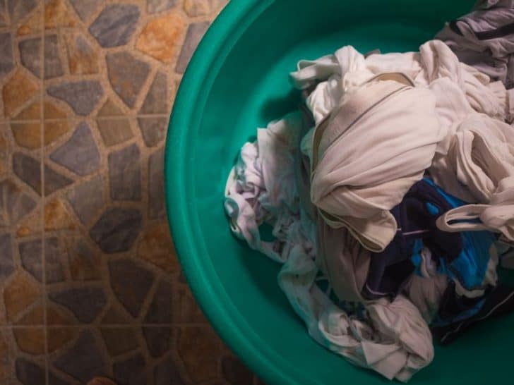 Overhead view of white and colored clothes mixed together in a laundry basket